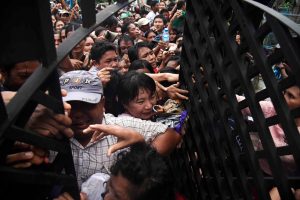 Hundreds of people jostle each other to enter a house compound in Thingangyun Township in Rangoon where a spirit event was taking place. (PHOTO: Thet Htoo / Myanmar Now)