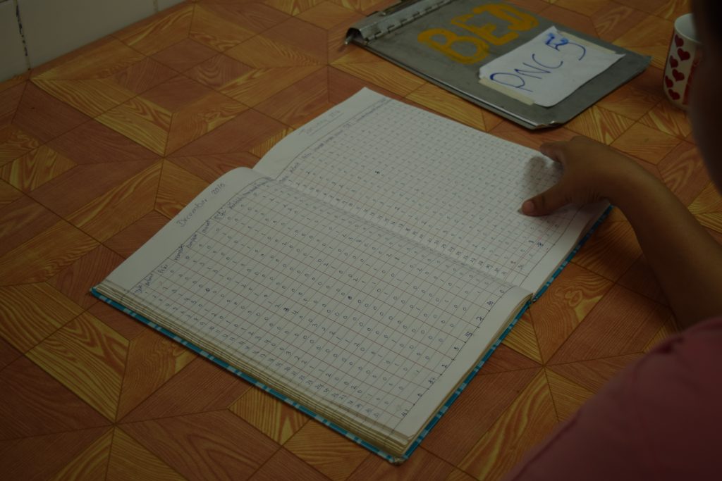 A healthcare worker looks over the records of incomplete abortion attempts. (PHOTO: KIMBERLEY PHILLIPS/DVB)