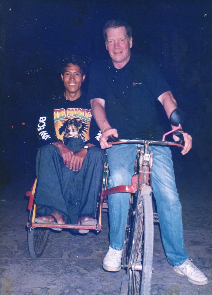 John Stevens Maung Maung Gyi, riding in his trishaw in 1996. (Photo: John Stevens)
