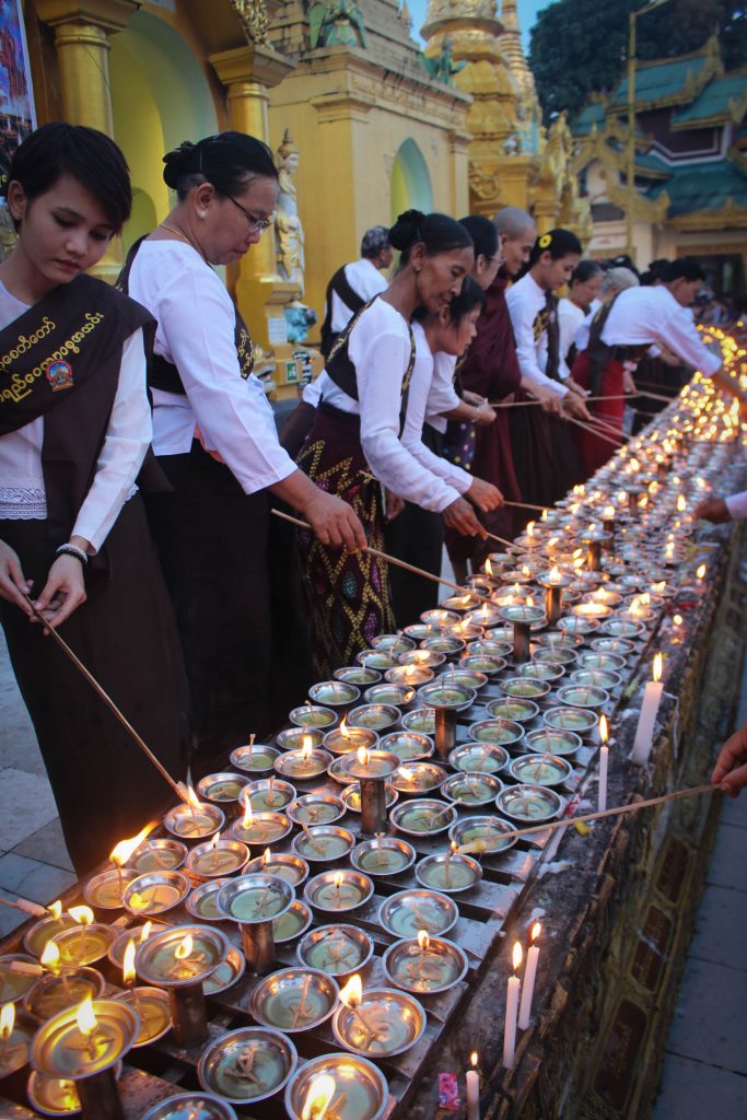Rows of candles being lit around Shwedagon Pagoda. (Photo: Libby Hogan / DVB)