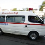 An ambulance rushes injured people to the hospital after series of explosions in Yangon