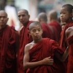 Buddhist monks wait for the funeral of a respected monk at Nyein Chan Yae monastery in Yangon