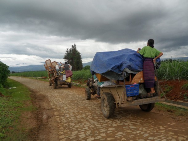 Ethnic Kachin refugees travel on vehicles with their belongings as they ...