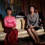 Myanmar’s democracy leader Aung San Suu Kyi and Thailand’s PM Yingluck pose for photos during their meeting at the Thai Embassy in Yangon