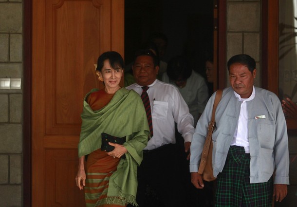 Myanmar's pro-democracy leader Suu Kyi leaves a hotel for the election ...