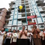 Members of the National Democratic Force party applaud at the opening ceremony of their Division Office in Yangon