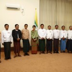 Myanmar’s pro-democracy leader Suu Kyi poses for a photo beside Tin Aye, the election commission chairman, while flanked by NLD leader Thin Oo after registering the NLD for any upcoming elections in Naypyitaw
