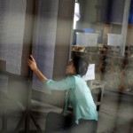 An election worker checks voters lists inside a polling station in central Yangon