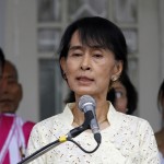 Myanmar pro-democracy leader Aung San Suu Kyi talks to reporters after meeting with Karen National Union representatives at her home in Yangon