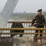 A Myanmar government soldier stands guard on Balaminhtin bridge over the Irrawaddy River near the city of Myitkyina