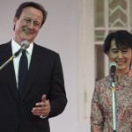 Britain’s PM Cameron and Nobel laureate Aung San Suu Kyi smile as they address reporters at her residence in Yangon
