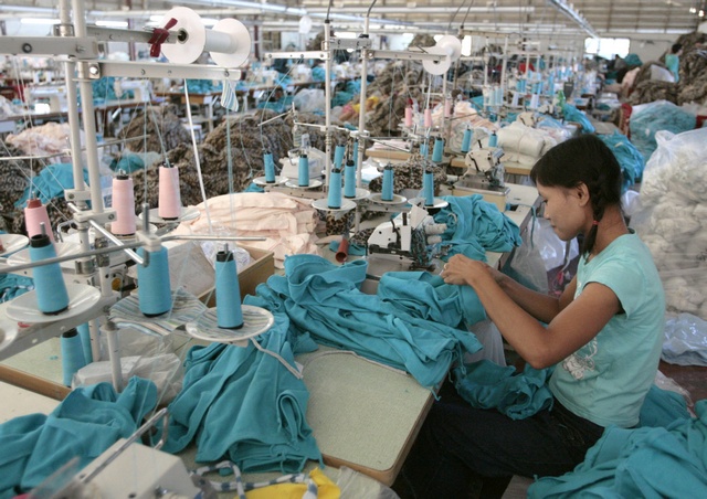 A Burmese migrant works in a Taiwan-owned garment factory in the northwestern Thai town of Mae Sot. Despite labour laws guaranteeing migrant workers basic rights such as a standard eight-hour working day, paid overtime and a minimum wage, the regulations are universally flouted. (Photo: Reuters)