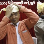 Elected candidate Thaw and counterparts try on Myanmar’s traditional cap at NLD head office in Yangon