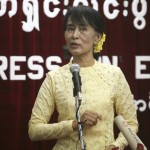 Myanmar’s opposition leader Aung San Suu Kyi gestures as she talks during a news conference about her Europe tour, at her party’s headquarters in Yangon