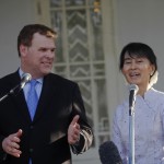 Myanmar’s pro-democracy leader Suu Kyi smiles as Canada’s Foreign Minister Baird talks to reporters after their meeting at Suu Kyi’s home in Yangon