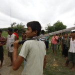 A Buddhist man holds a machete as he and other members of the community guard their homes in Sittwe