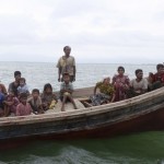 Rohingya refugees from Myanmar are seen on a boat while they try to get into Bangladesh