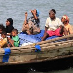 Myanmar’s Muslim Rohingya people on a boat cross the river Naf, from Myanmar into Bangladesh, in Teknaf