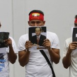 Buddhist Myanmar citizens living in Thailand held portraits of Myanmar’s President Thein Sein as they gather outside the Myanmar embassy in Bangkok