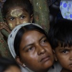 People displaced by recent violence in the Kyukphyu township gather after arriving at Thaechaung refugee camp