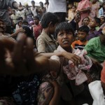 People displaced by recent violence in Kyukphyu township reach for aid donated in Thaechaung refugee camp