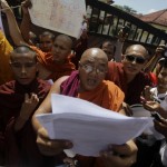 Buddhist monk reads a statement during a protest in front of the Bangladeshi embassy in Yangon