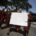 Buddhist monks hold a placard as they protest against the opening of Organization of Islamic Cooperation offices in Myanmar
