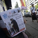 A man reads a local news journal with an image of U.S. President Obama in Yangon