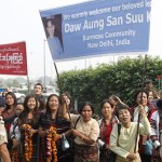 Supporters of Myanmar’s opposition leader Kyi hold banners to welcome her at the Indira Gandhi international airport in New Delhi