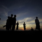 Muslims who escaped recent violence in Kyukphyu gather on beach near a refugee camp outside of Sittwe