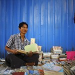 A street vendor is pictured as he sells second hand books on the streets of Yangon