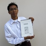 Sithu Zeya, a 22-year-old journalist, shows a picture of his cell that he drew while in prison, in his home in Yangon