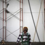 A labourer walks in a swimming pool complex that is being built for the 2013 Southeast Asian Games in Nay Pyi Taw
