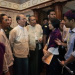 Myanmar’s President Thein Sein speaks with ethnic Kachin youths after a meeting with representatives from civil societies at the Yangon Region Parliament Building in Yangon