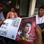 Delegates read a local news journal containing news about the NLD’s congress before attending the day’s session of the congress in Yangon