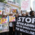 Myanmar Muslims in Malaysia show banners and placards during a demonstration against the killings of Muslims in Meikhtila, in Kuala Lumpur
