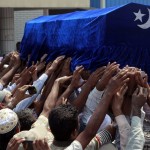 Muslims carry the coffin of a victim of a fire during a funeral at Yaeway cemetery in Yangon