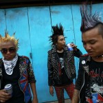 Youths dressed as punks drink beer as they wait for a punk music show during the Myanmar New Year Water Festival in Yangon