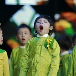 A boy waits to perform at the opening ceremony of a water pavilion during a celebration for Thingyan in Yangon