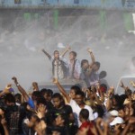 People celebrate by getting sprayed with water as they celebrate the Myanmar New Year Water Festival in Yangon