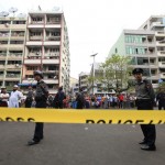 Police stand near a mosque and school dormitory that were damaged by a fire in Yangon