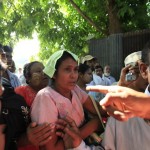 The mother of a boy who died in a fire at an Islamic school arrives at a hospital to see her son’s body in Yangon