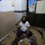 Zayar Phyo, who is in charge of a mosque and a survivor of a fire that damaged it and a school dormitory, talks on a phone in Yangon