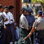 Muslim men accused of murdering a monk, believed to be the first killing in the March unrest, are escorted by police out of court in Meikhtila