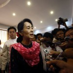 Myanmar pro-democracy leader Aung San Suu Kyi talks to reporters after giving a speech in Yangon