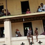 People pass time in a mosque, where they were evacuated to shelter from cyclone Mahasen when it landed, outside of Sittwe
