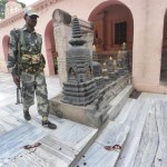 An Indian security personnel walks next to bloody footprints inside the Mahabodhi temple complex at Bodh Gaya