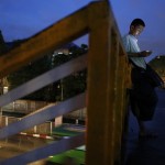 A man use his mobile phone on a bridge in central Yangon