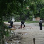 Policemen clear debris off a road near a shop owned by Muslims that was destroyed at Htan Kone village, in Myanmar’s northern Sagaing region