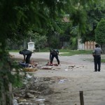 Policemen-clear-debris-off-a-road-near-a-shop-owned-by-Muslims-that-was-destroyed-at-Htan-Kone-village-in-Myanmars-northern-Sagaing-region